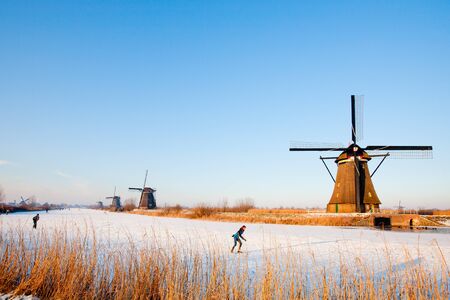 KINDERDIJK - FEBRUARY 4, 2012: Start of the skating period in the Netherlands at the Dutch historic windmills in Kinderdijk, february 4, 2012 in the Netherlandsのeditorial素材
