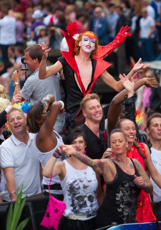 AMSTERDAM, THE NETHERLANDS - AUGUST 4, 2012: Participants dance in front of spectators at the famous Canal Parade of the Amsterdam Gay Pride 2012 on August 4, 2012 in Amsterdamのeditorial素材