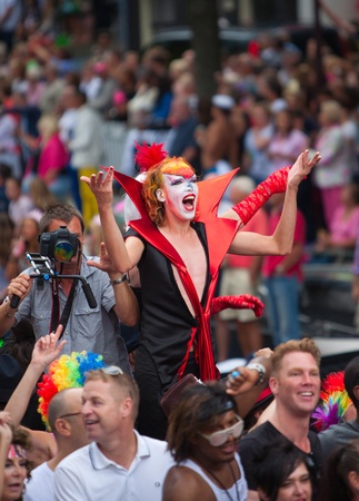 AMSTERDAM, THE NETHERLANDS - AUGUST 4, 2012: Participants dance in front of spectators at the famous Canal Parade of the Amsterdam Gay Pride 2012 on August 4, 2012 in Amsterdamのeditorial素材