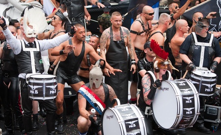 AMSTERDAM, THE NETHERLANDS - AUGUST 4, 2012: Participants dance in front of spectators at the famous Canal Parade of the Amsterdam Gay Pride 2012 on August 4, 2012 in Amsterdamのeditorial素材