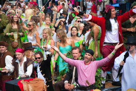 AMSTERDAM, THE NETHERLANDS - AUGUST 4, 2012: Participants dance in front of spectators at the famous Canal Parade of the Amsterdam Gay Pride 2012 on August 4, 2012 in Amsterdamのeditorial素材