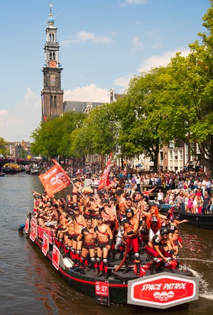 AMSTERDAM, THE NETHERLANDS - AUGUST 4, 2012: Participants dance in front of spectators at the famous Canal Parade of the Amsterdam Gay Pride 2012 on August 4, 2012 in Amsterdamのeditorial素材