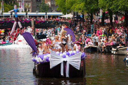 AMSTERDAM, THE NETHERLANDS - AUGUST 4, 2012: Participants dance in front of spectators at the famous Canal Parade of the Amsterdam Gay Pride 2012 on August 4, 2012 in Amsterdamのeditorial素材
