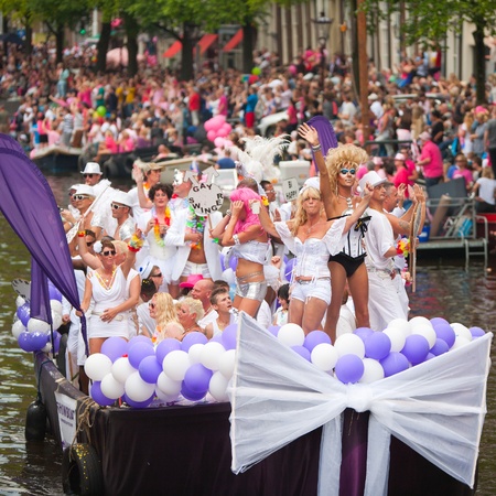 AMSTERDAM, THE NETHERLANDS - AUGUST 4, 2012: Participants dance in front of spectators at the famous Canal Parade of the Amsterdam Gay Pride 2012 on August 4, 2012 in Amsterdamのeditorial素材