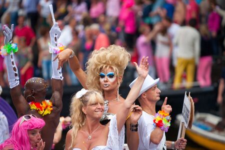 AMSTERDAM, THE NETHERLANDS - AUGUST 4, 2012: Participants dance in front of spectators at the famous Canal Parade of the Amsterdam Gay Pride 2012 on August 4, 2012 in Amsterdamのeditorial素材
