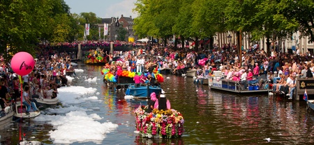 AMSTERDAM, THE NETHERLANDS - AUGUST 4, 2012: Participants dance in front of spectators at the famous Canal Parade of the Amsterdam Gay Pride 2012 on August 4, 2012 in Amsterdamのeditorial素材