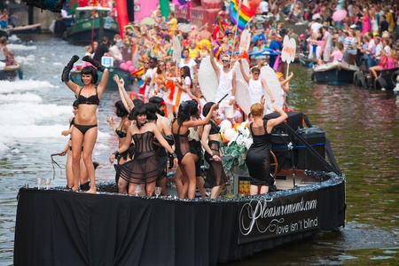 AMSTERDAM, THE NETHERLANDS - AUGUST 4, 2012: Participants dance in front of spectators at the famous Canal Parade of the Amsterdam Gay Pride 2012 on August 4, 2012 in Amsterdamのeditorial素材
