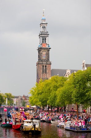 AMSTERDAM, THE NETHERLANDS - AUGUST 4, 2012: Participants dance in front of spectators at the famous Canal Parade of the Amsterdam Gay Pride 2012 on August 4, 2012 in Amsterdamのeditorial素材