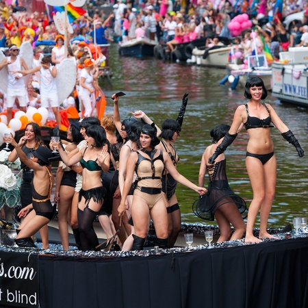 AMSTERDAM, THE NETHERLANDS - AUGUST 4, 2012: Participants dance in front of spectators at the famous Canal Parade of the Amsterdam Gay Pride 2012 on August 4, 2012 in Amsterdamのeditorial素材
