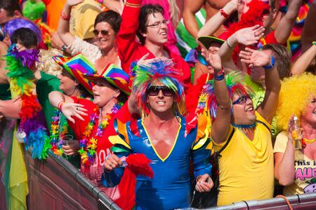 AMSTERDAM, THE NETHERLANDS - AUGUST 4, 2012: Participants dance in front of spectators at the famous Canal Parade of the Amsterdam Gay Pride 2012 on August 4, 2012 in Amsterdamのeditorial素材