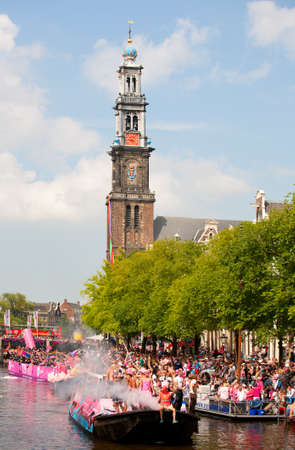 AMSTERDAM, THE NETHERLANDS - AUGUST 4, 2012: Participants dance in front of spectators at the famous Canal Parade of the Amsterdam Gay Pride 2012 on August 4, 2012 in Amsterdamのeditorial素材
