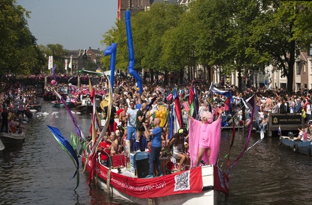AMSTERDAM, THE NETHERLANDS - AUGUST 4, 2012: Participants dance in front of spectators at the famous Canal Parade of the Amsterdam Gay Pride 2012 on August 4, 2012 in Amsterdamのeditorial素材