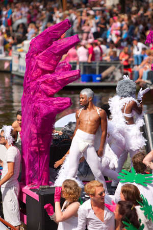 AMSTERDAM, THE NETHERLANDS - AUGUST 4, 2012: Participants dance in front of spectators at the famous Canal Parade of the Amsterdam Gay Pride 2012 on August 4, 2012 in Amsterdamのeditorial素材