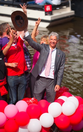 AMSTERDAM, THE NETHERLANDS - AUGUST 4, 2012: Politician Ronald Plassterk and other participants in front of spectators at the famous Canal Parade of the Amsterdam Gay Pride 2012 on August 4, 2012 in Amsterdamのeditorial素材
