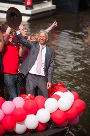 AMSTERDAM, THE NETHERLANDS - AUGUST 4, 2012: Politician Ronald Plassterk and other participants dance in front of spectators at the famous Canal Parade of the Amsterdam Gay Pride 2012 on August 4, 2012 in Amsterdamのeditorial素材