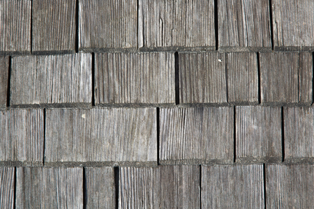 Traditional wooden shingles wall of an Austrian houseの写真素材