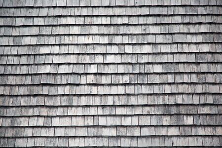 Traditional wooden shingles wall of an Austrian houseの写真素材