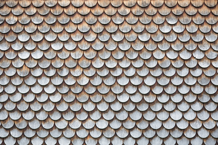Traditional wooden shingles wall of an Austrian houseの写真素材