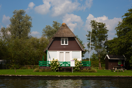 National Park De Alde Feanen, Friesland, The Netherlands - August 21, 2018; Holiday home on the waterfront for sale, Friesland, The Netherlandsのeditorial素材