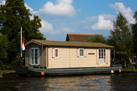 National Park De Alde Feanen, Friesland, The Netherlands - August 21, 2018; House boat on the waterfront for sale, Friesland, The Netherlandsのeditorial素材