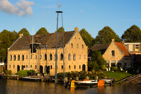 Dokkum, Friesland, The Netherlands - August 17, 2018; Warehouse the Nijverheid on a canal of historic town Dokkum, Friesland, The Netherlandsのeditorial素材