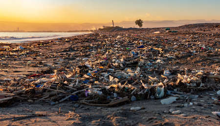 A lot of rubbish in a beach at sunset in mersin, turkeyの写真素材