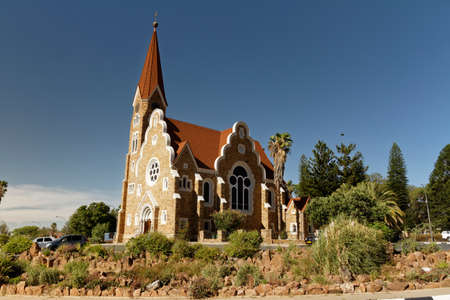 The Christ Church, Christuskirche is a historic landmark and Lutheran church in Windhoek, Namibia. Blue sky and palm treesの写真素材