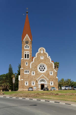 The Christ Church, Christuskirche is a historic landmark and Lutheran church in Windhoek, Namibia. Blue sky, palm trees and the moonの写真素材