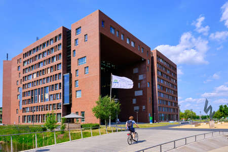 Wageningen, the Netherlands, May 26,2020:Forum at Wageningen Campus in Sunshine, with flag and cyclistのeditorial素材