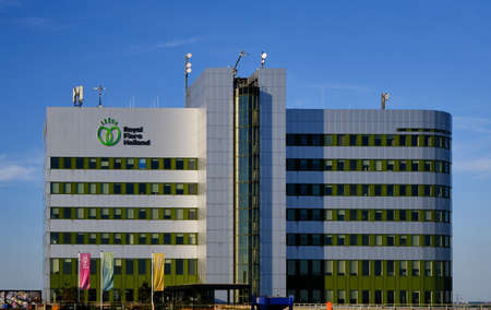 Honselersdijk, the Netherlands,June 24,2020:Main office building Flora Holland flower auction at Honselersdijk, Naaldwijk. With logo text and flags.のeditorial素材