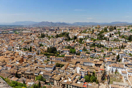 Aerial view of the city Granada from fortress Alhambra, Andalusia, Spain. With mountain range in backgroundの写真素材