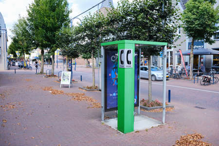 Bennekom, Netherlands. Aug,18,2020. Old Green Phone booth in shopping district, one of the last. Green pay phone for general usage, disappear from the streets.の写真素材