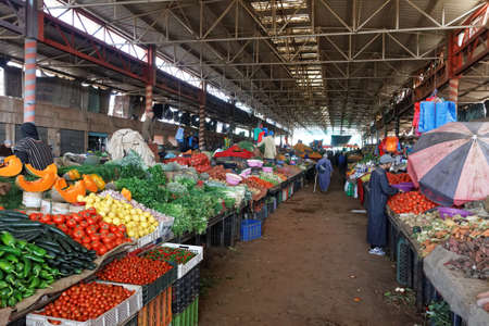 Agadir,Morocco-Feb 7,2019:Souk El Had, centre of Agadir. The market offers fresh fruit, vegetables, herbs and traditional Moroccan goods. Men selling vegetables, herbs in a large hall near the soukのeditorial素材
