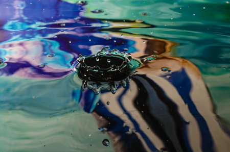 Water drop collision on a water surface. Splash effect after collision a falling drops with water Surfaceの写真素材