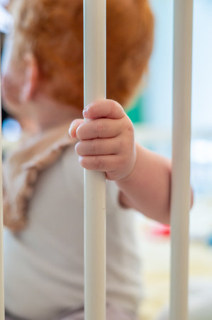 Little boy standing in a hospital bed and looking away from the camera. Selective focus.の写真素材
