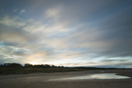 sunrise coloured sky at coastlineの写真素材