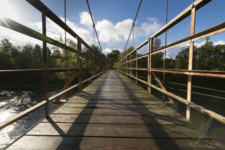 hanging footbridge at sunny morningの写真素材