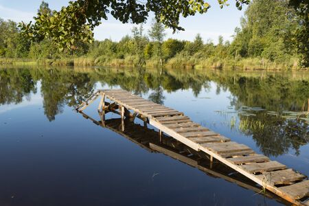 footbridge in the lake at sunriseの写真素材
