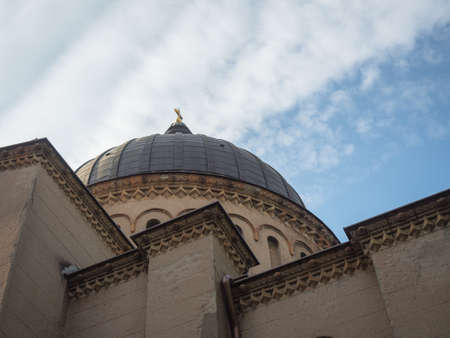 Picture of the dome of the cathedral from below. Building with dark dome and sculpting on the light-beige coloured wall. Holy Cross on the dome of the cathedral.の写真素材