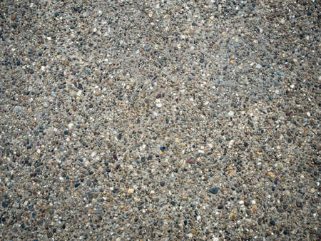 Background of gray stones texture close up. A mosaic of tiny gravel stones. Tiny gravel stones pattern.の写真素材