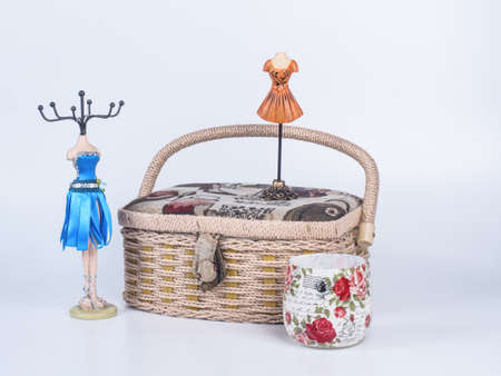 Composition of beige-coloured box with stand for bijouterie and candle in glass on white background....