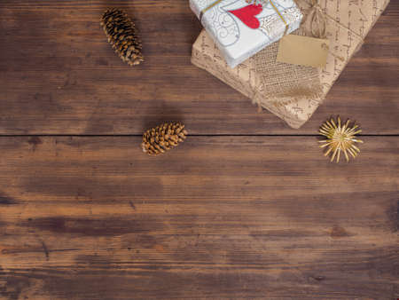 Vintage gift box, fir cones with Christmas toy on wood background with copy space for text. Top...