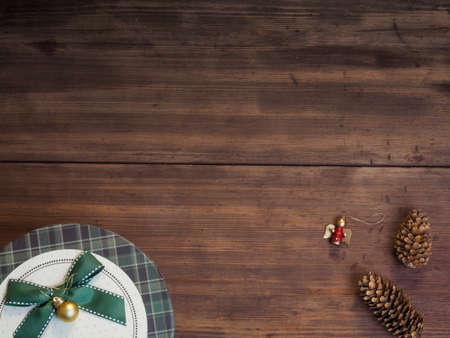 Vintage gift box, fir cones with Christmas toy on wood background with copy space for text. Top view, Studio photographyの写真素材