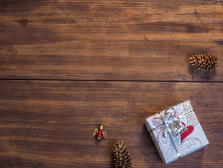 Vintage gift box, fir cones with Christmas toy on wood background with copy space for text. Top view, Studio photographyの写真素材