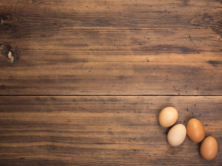 Easter eggs on old wooden table from planks. Top view with space for your design, Easter greetings...