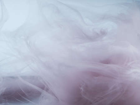 Abstract colored background. Colored smoke, ink in water, the patterns of the universe. Abstract movement, frozen multicolor flow of paint. Horizontal photo with soft focus, blurred backdrop.の写真素材