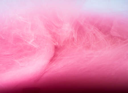 Abstract colored background. Pink smoke, ink in water, the patterns of the universe. Abstract movement, frozen multicolor flow of paint. Horizontal photo with soft focus, blurred backdrop.の写真素材