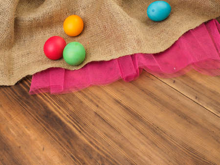Easter colored egg. Mock up for your greetings card or design. Russian and Ukrainian, orthodox, slavic traditional Easter, rural background with burlap and colored meshの写真素材