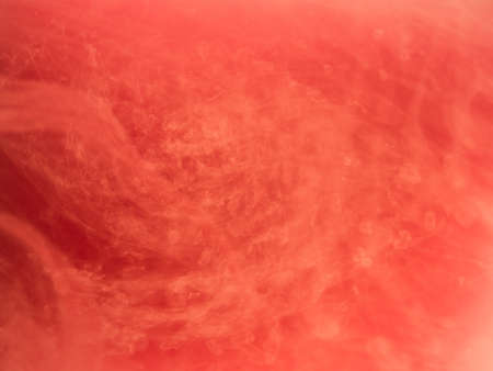 Abstract colored background. Pink smoke, ink in water, the patterns of the universe. Abstract movement, frozen multicolor flow of paint. Horizontal photo with soft focus, blurred backdrop.の写真素材