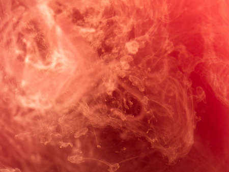 Abstract colored background. Pink smoke, ink in water, the patterns of the universe. Abstract movement, frozen multicolor flow of paint. Horizontal photo with soft focus, blurred backdrop.の写真素材